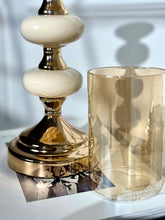 High Objects Pebble Luxe Candle Stand Set with cream ceramic and gold accents, featuring a tinted glass hurricane.