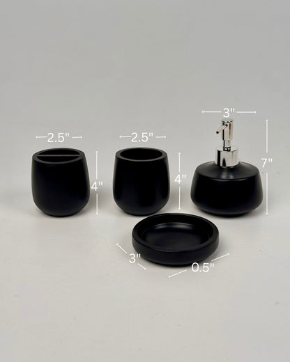 High Objects Pebbleease black bathroom accessory set with soap dispenser, toothbrush holder, and dish. Smooth, organic shapes.