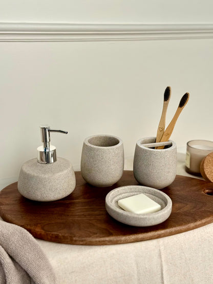 High Objects Pebbleease Bathroom Accessory Set: speckled grey soap dispenser, toothbrush holder, tumbler, and soap dish.