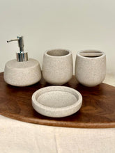 High Objects Pebbleease Bathroom Accessory Set: speckled stone soap dispenser, tumbler, toothbrush holder, and dish.