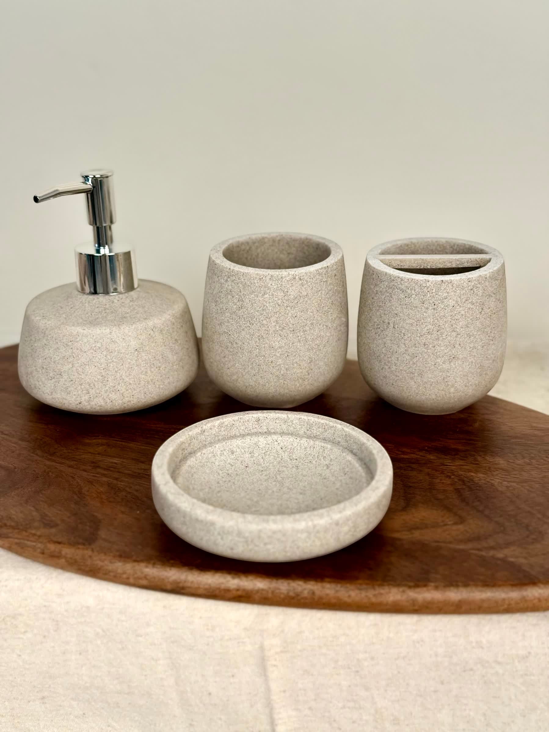 High Objects Pebbleease Bathroom Accessory Set: speckled stone soap dispenser, tumbler, toothbrush holder, and dish.