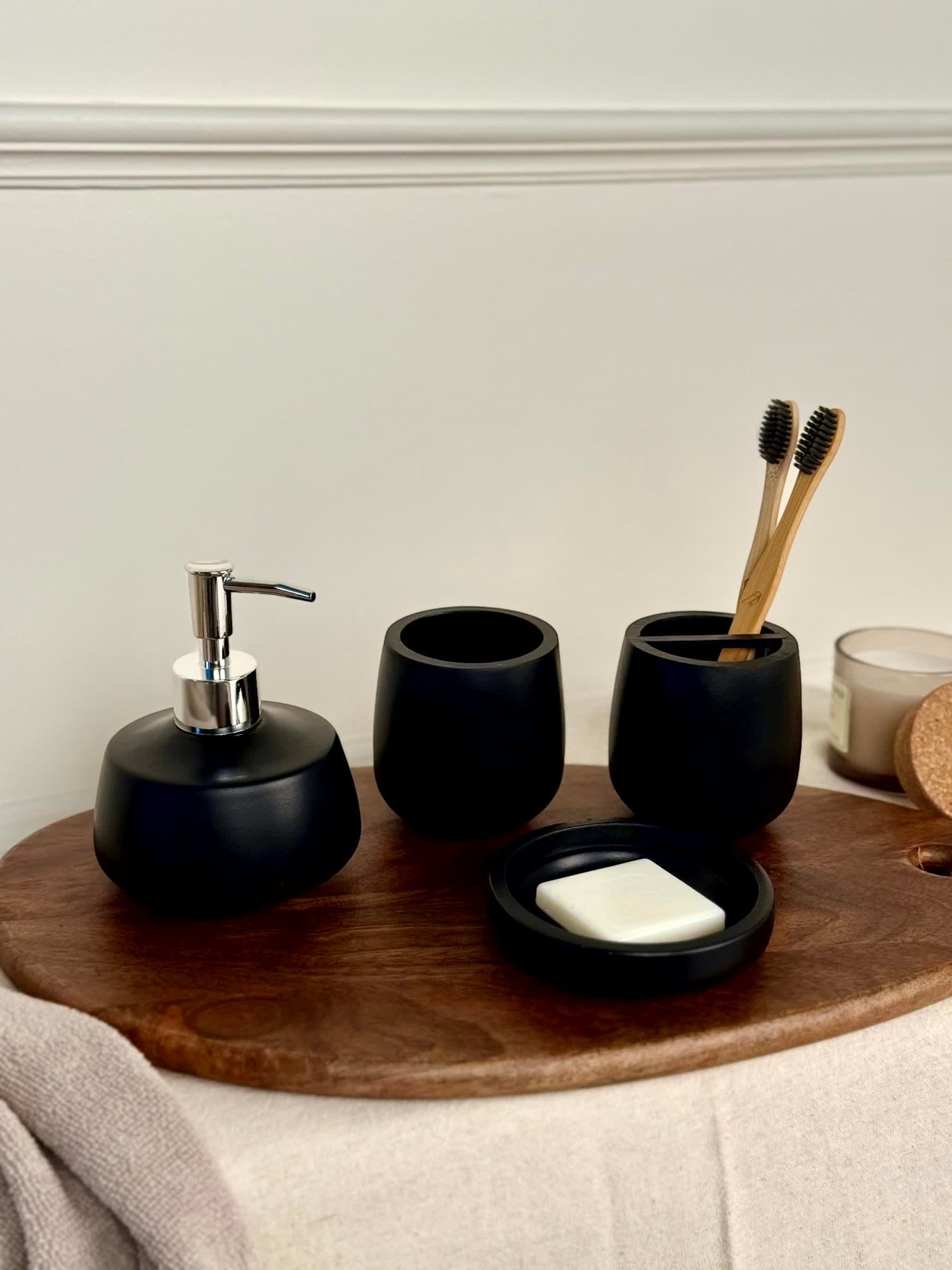 High Objects Pebbleease black bathroom accessory set with soap dispenser, toothbrush holder, and soap dish.