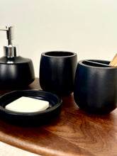 High Objects Pebbleease black bathroom accessory set with soap dish, dispenser, and tumbler.