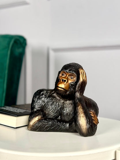 High Objects Pensive Gorilla showpiece sculpture with a golden face and black textured body, resting head on hand.