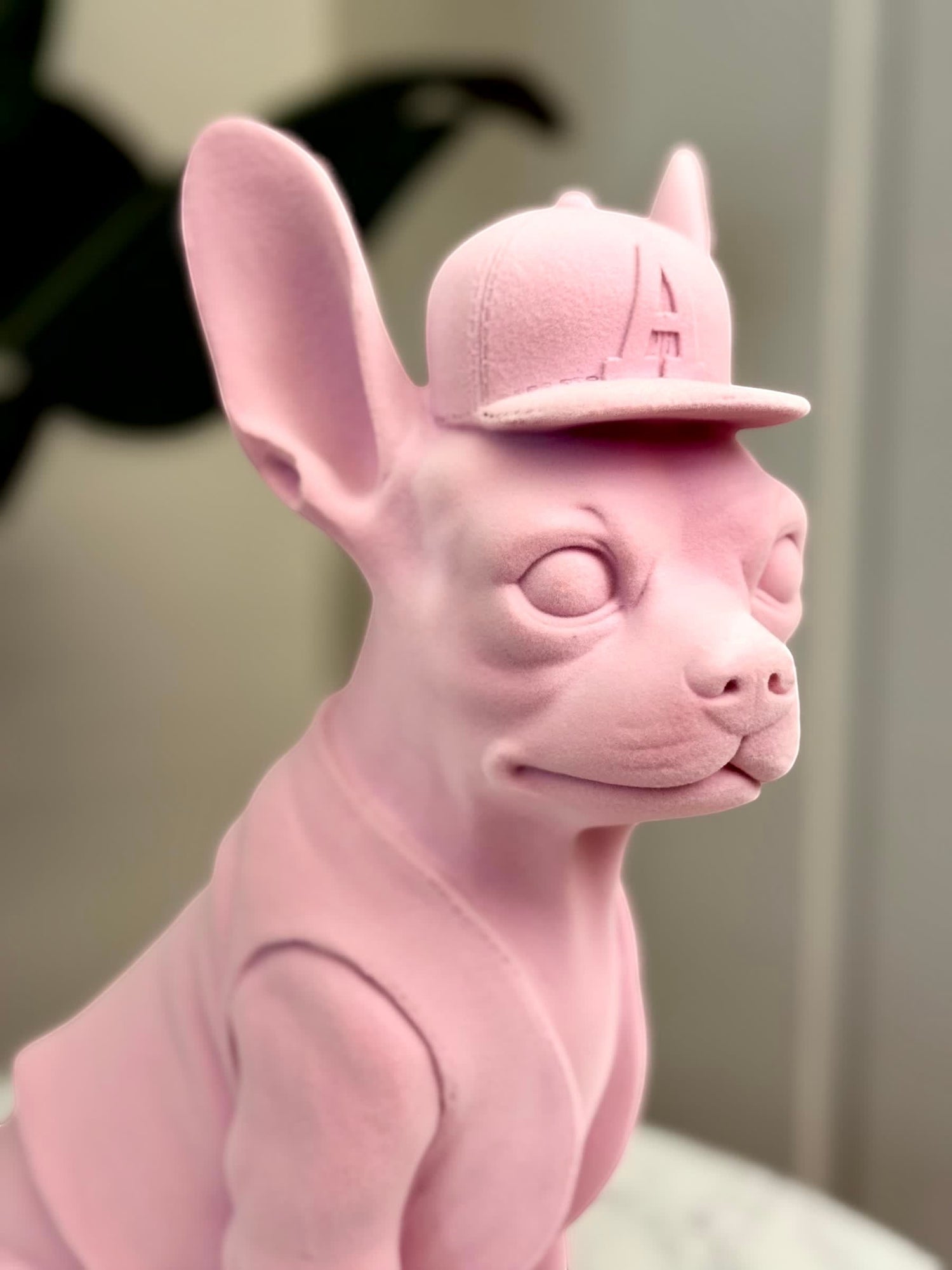 High Objects matte pink French bulldog sculpture wearing a baseball cap with an &