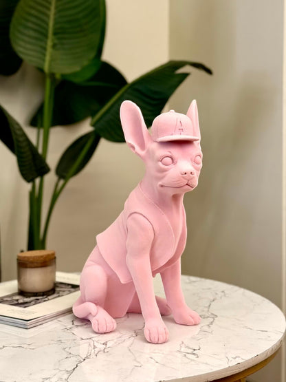 High Objects matte pink French bulldog sculpture wearing a baseball cap and vest. Modern decor accent.