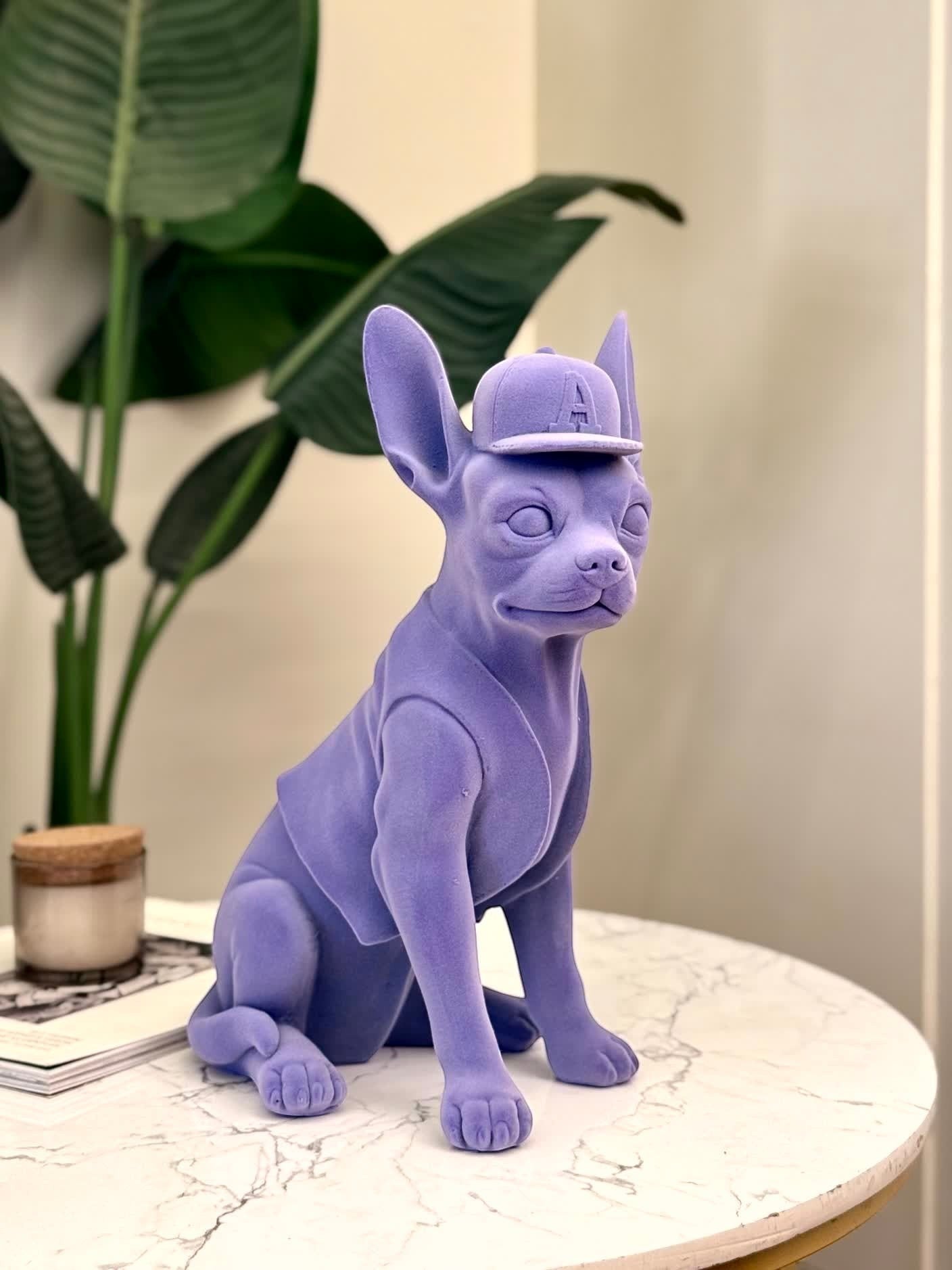 High Objects matte purple French bulldog sculpture wearing a baseball cap and vest.