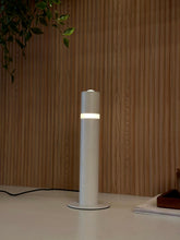 High Objects Pureline white cylindrical table lamp with a mid-band detail, providing soft ambient light.