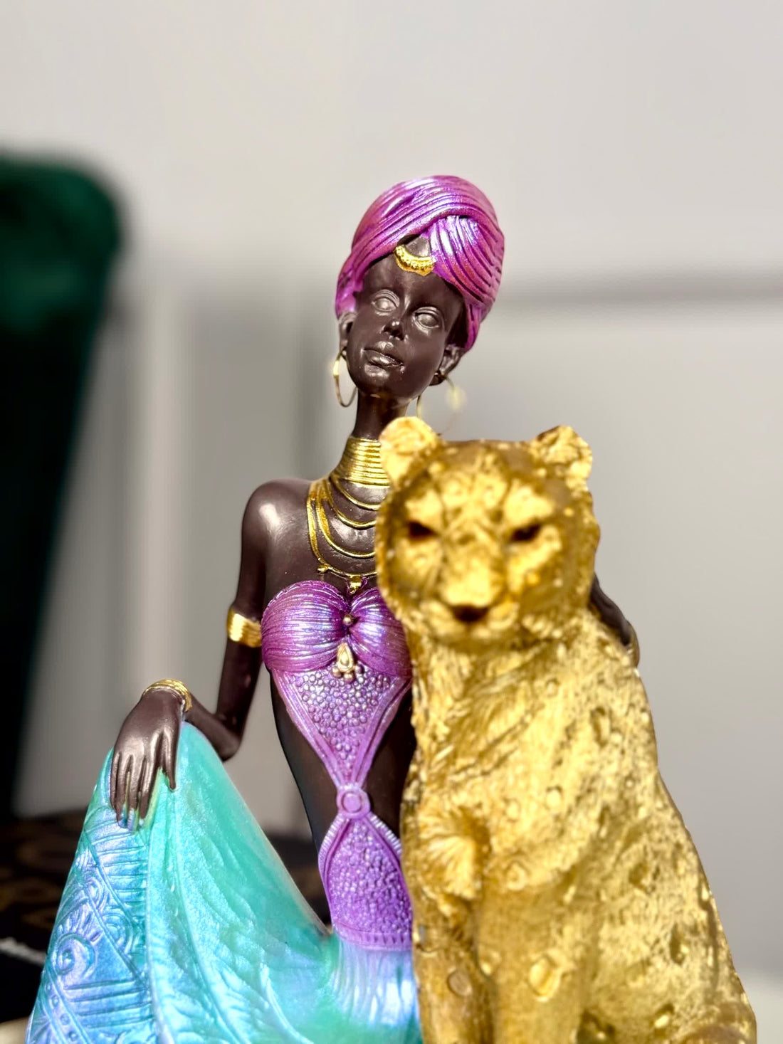 High Objects Queen of the Wild showpiece: African woman in jewel-toned attire with leopard sculpture.