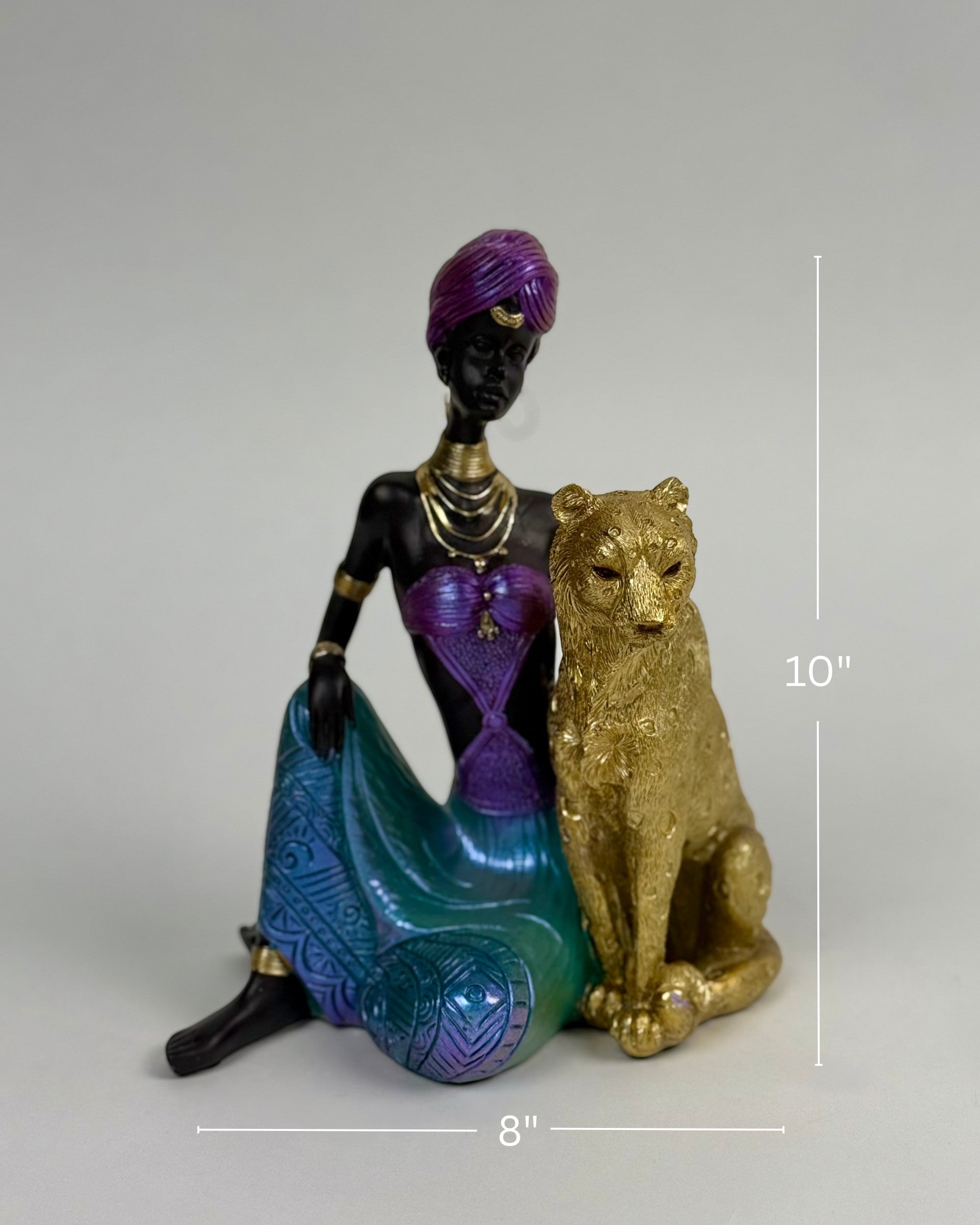 High Objects Queen of the Wild showpiece: African woman in purple turban and jewel-toned skirt with leopard sculpture.