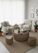 High Objects Rattan Circle Coffee Table Set with wooden top and four stools with woven rattan bases.