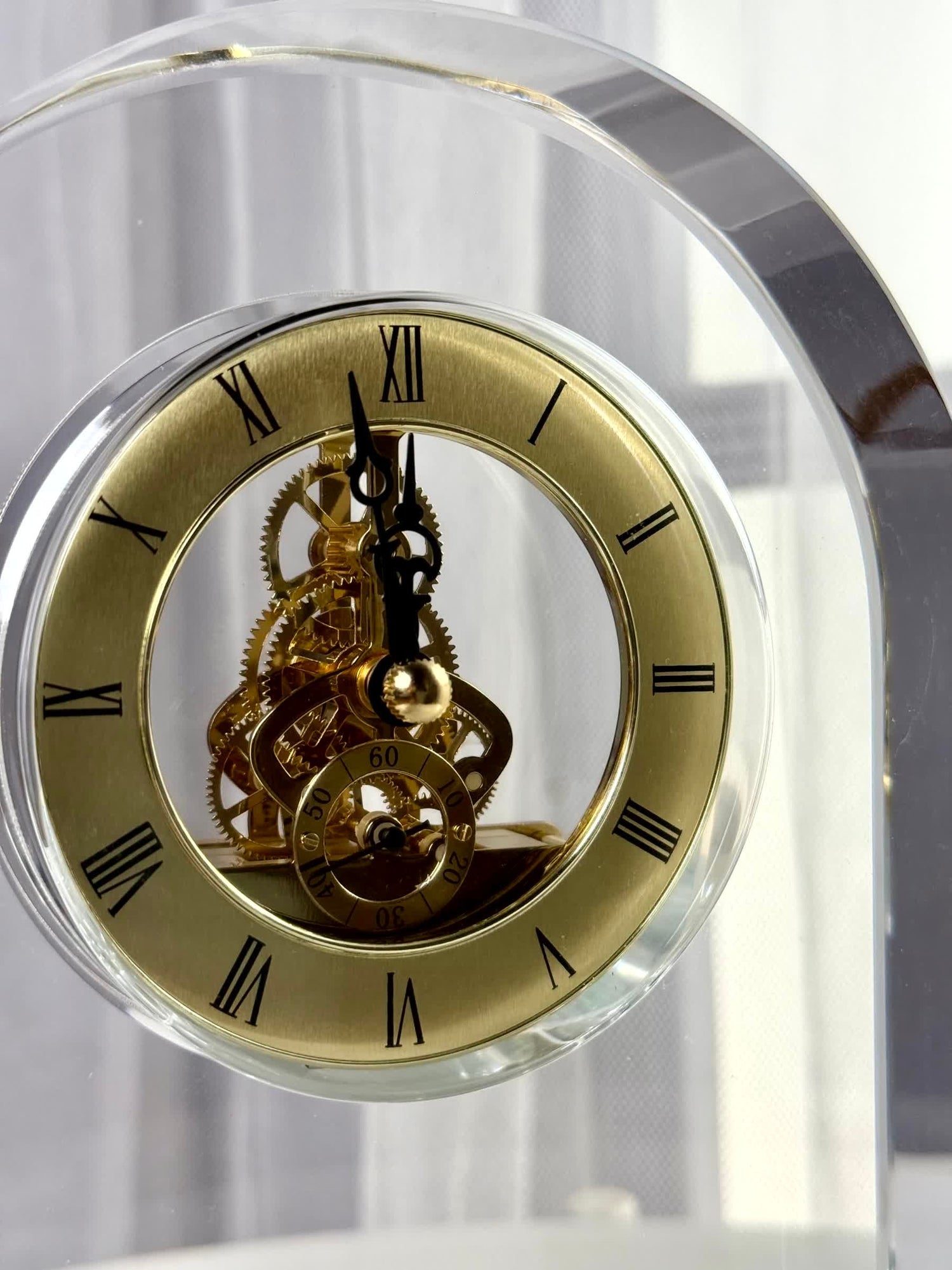 High Objects Regal Crystal Desk Clock with gold Roman numerals and exposed gears. Polished crystal arched silhouette.