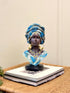 High Objects Regal Essence Woman Showpiece bust with blue patterned headwrap and gold jewelry.