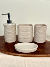 High Objects Ridgeline Bathroom Accessory Set: lotion dispenser, soap dish, and two tumblers in speckled beige with horizontal ridges.