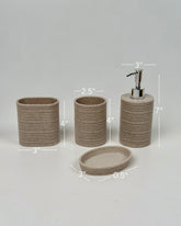 High Objects Ridgeline bathroom accessory set in speckled beige with horizontal ridges. Includes soap dispenser, toothbrush holder, and soap dish.