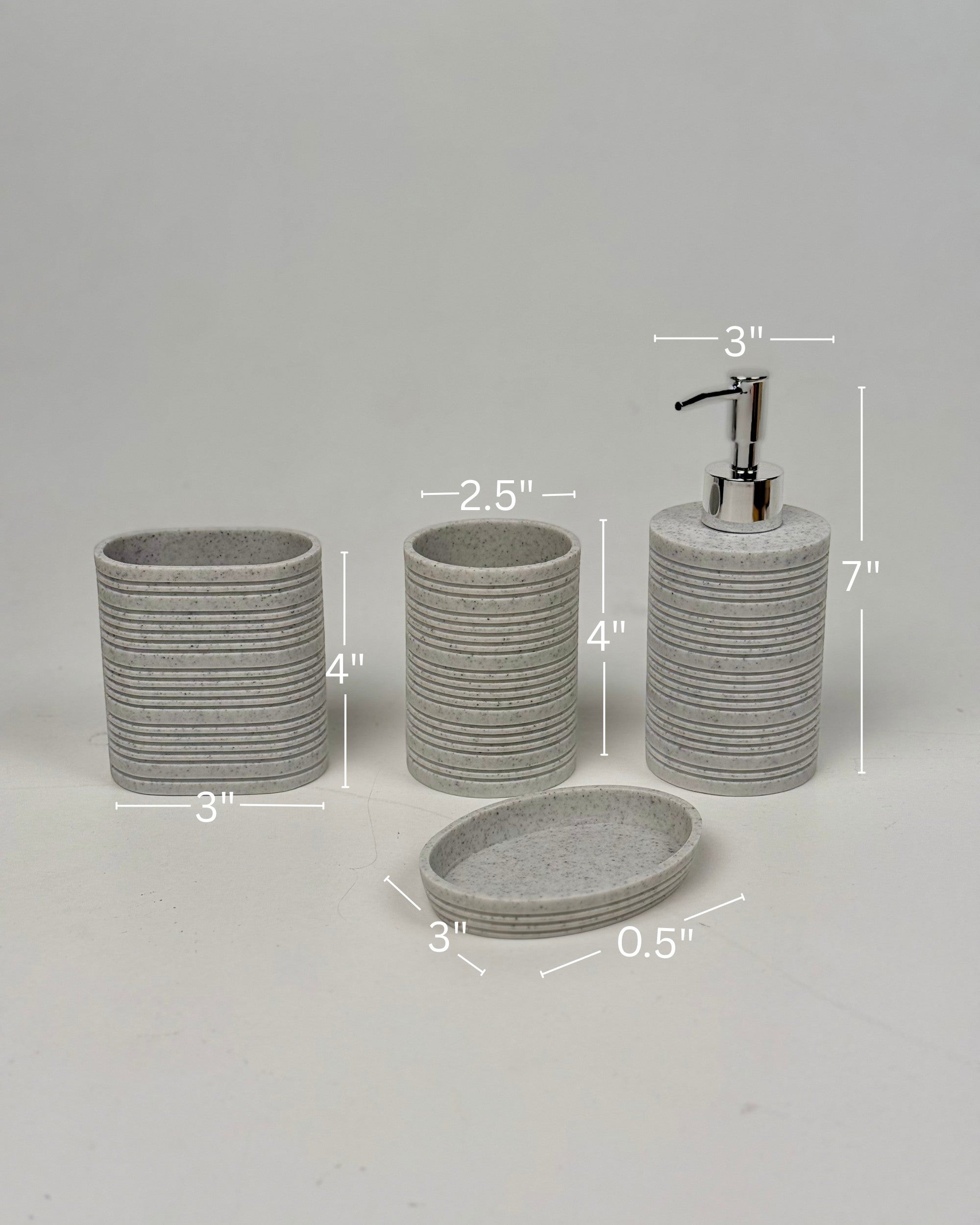 High Objects Ridgeline Bathroom Accessory Set: speckled grey resin soap dispenser, toothbrush holder, cup, and soap dish with horizontal ridges.