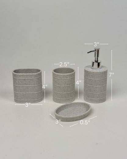 High Objects Ridgeline Bathroom Accessory Set: speckled grey resin soap dispenser, toothbrush holder, cup, and soap dish with horizontal ridges.