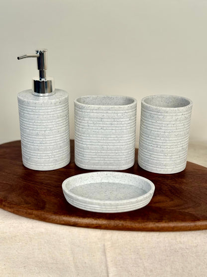 High Objects Ridgeline Bathroom Accessory Set: lotion dispenser, soap dish, and two tumblers in speckled white with horizontal ridges.