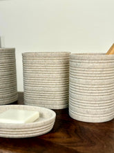 High Objects Ridgeline Bathroom Accessory Set in speckled stone with horizontal ridges. Includes soap dish and tumblers.