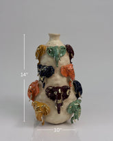 High Objects Safari Heritage Elephant Art Showpiece vase, 14" tall, with colorful elephant heads and gold tusks on a rustic textured body.