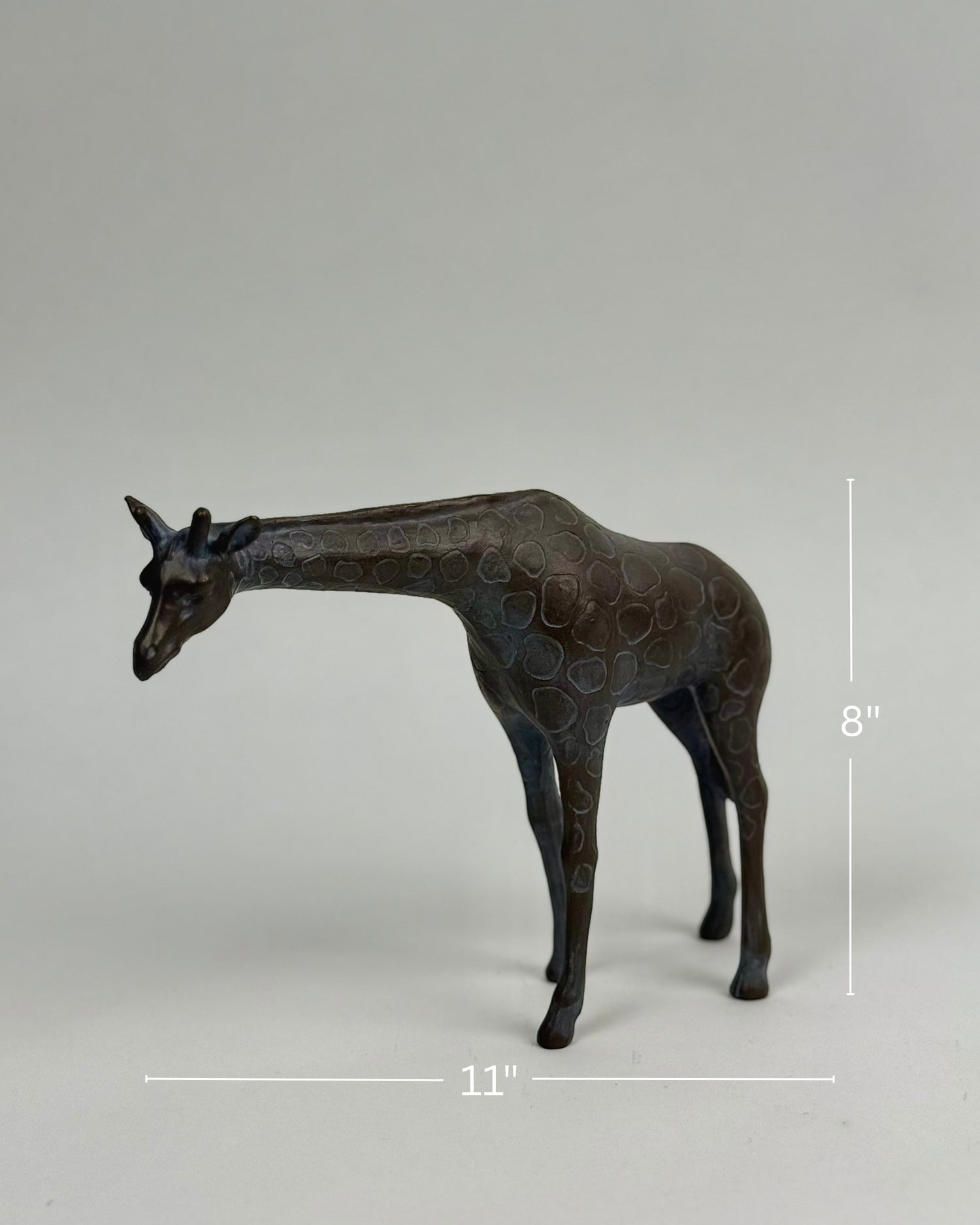 High Objects Savannah Grace polyresin giraffe showpiece, 8" tall, 11" wide, neutral tone with textured spots.