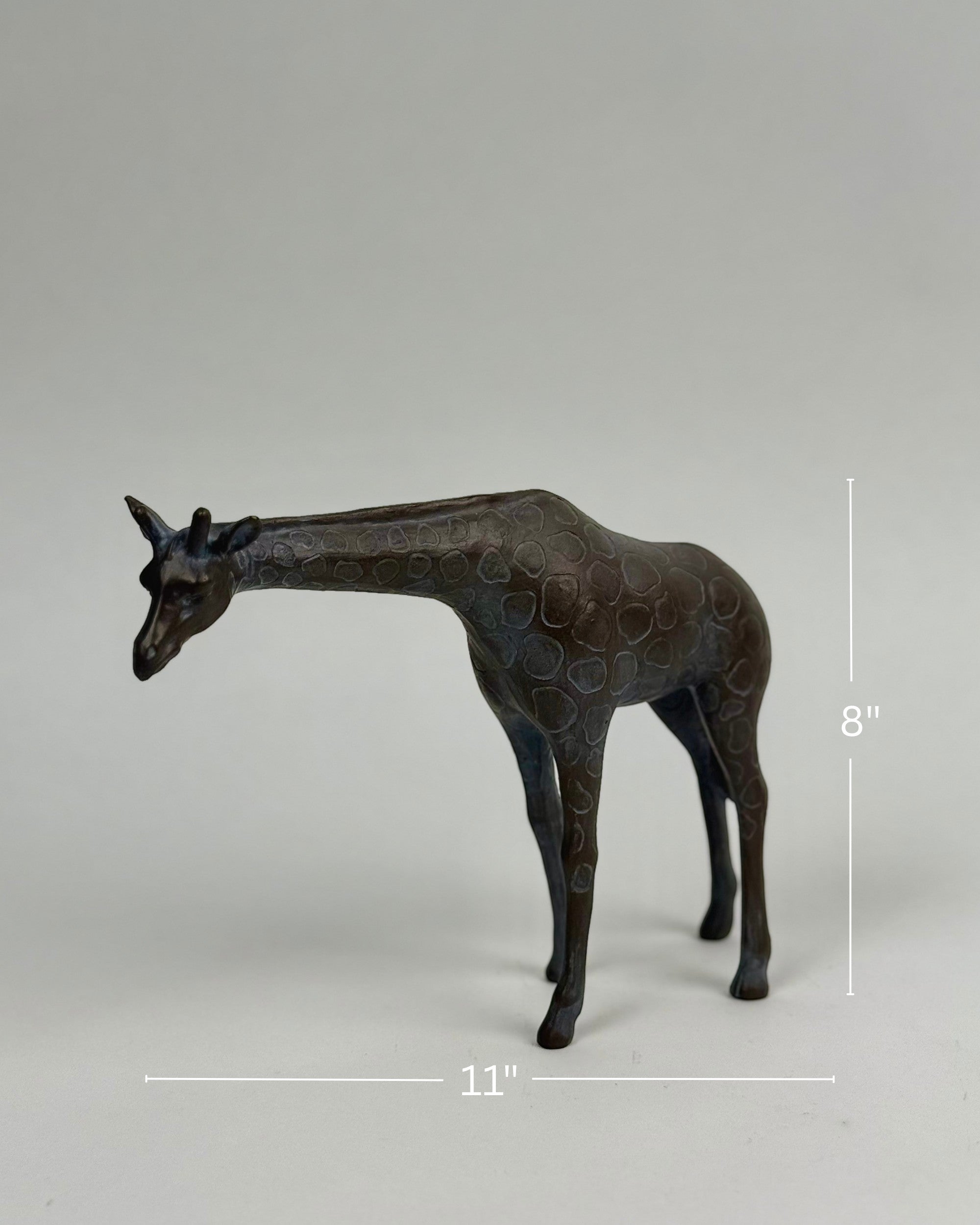 High Objects Savannah Grace polyresin giraffe showpiece, 8" tall, 11" wide, neutral tone with textured spots.