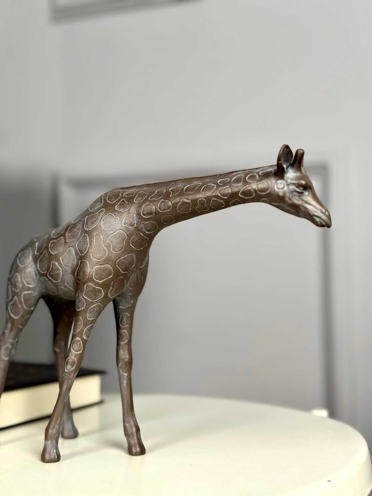 High Objects Savannah Grace showpiece, a bronze-toned polyresin giraffe sculpture with subtle texture and detailed spots.