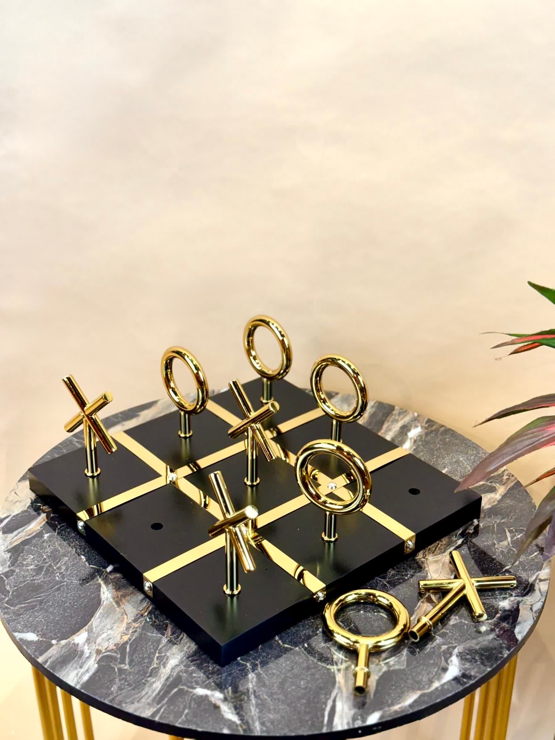 High Objects Sculpted Gold Tic-Tac-Toe Set with black MDF board and gold finished iron X and O pieces.