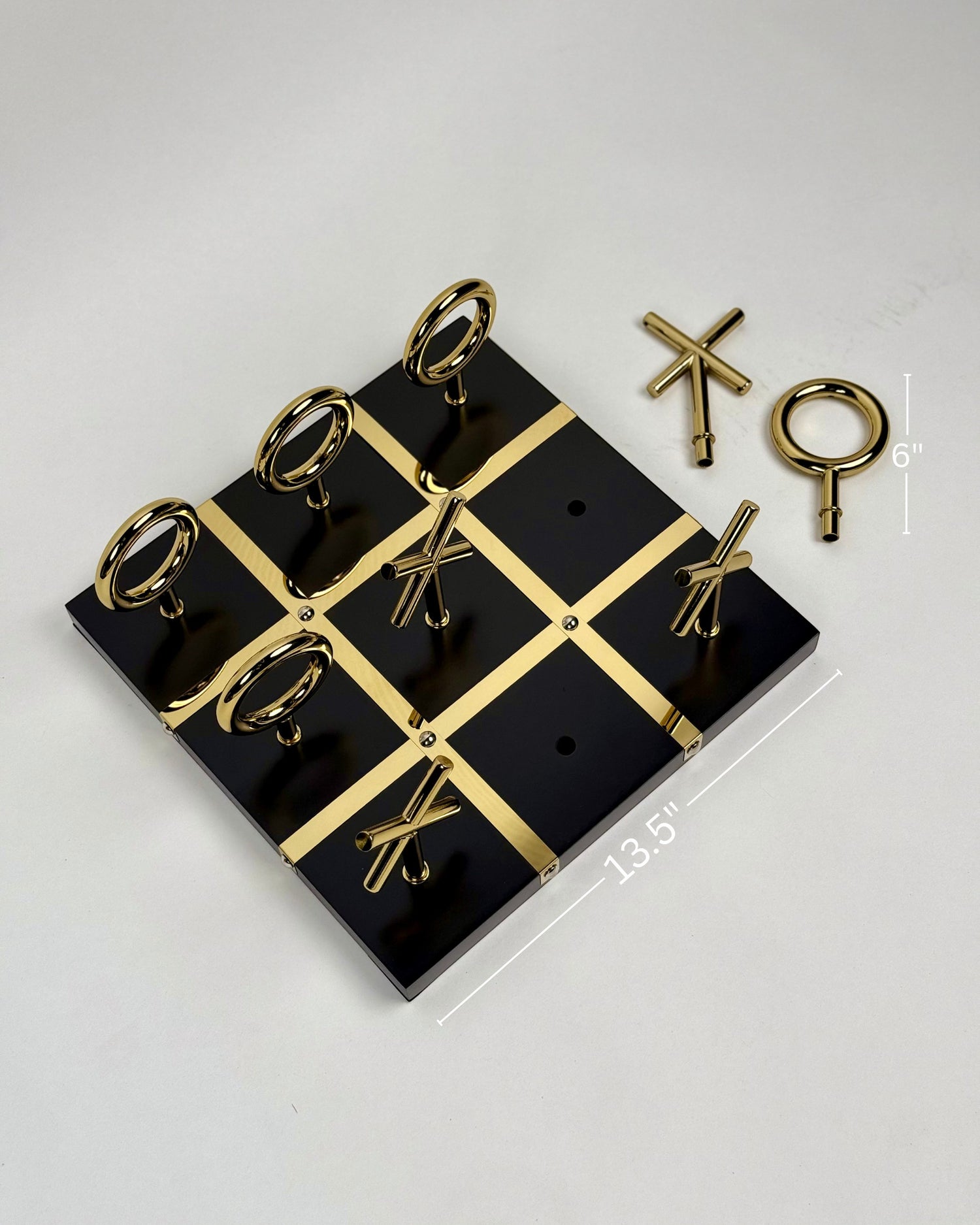 High Objects Sculpted Gold Tic-Tac-Toe Set with black MDF board and gold-finished iron X and O pieces.