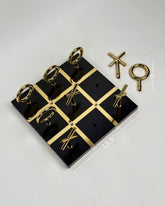 High Objects Sculpted Gold Tic-Tac-Toe Set with black MDF board and gold-finished iron X and O pieces.