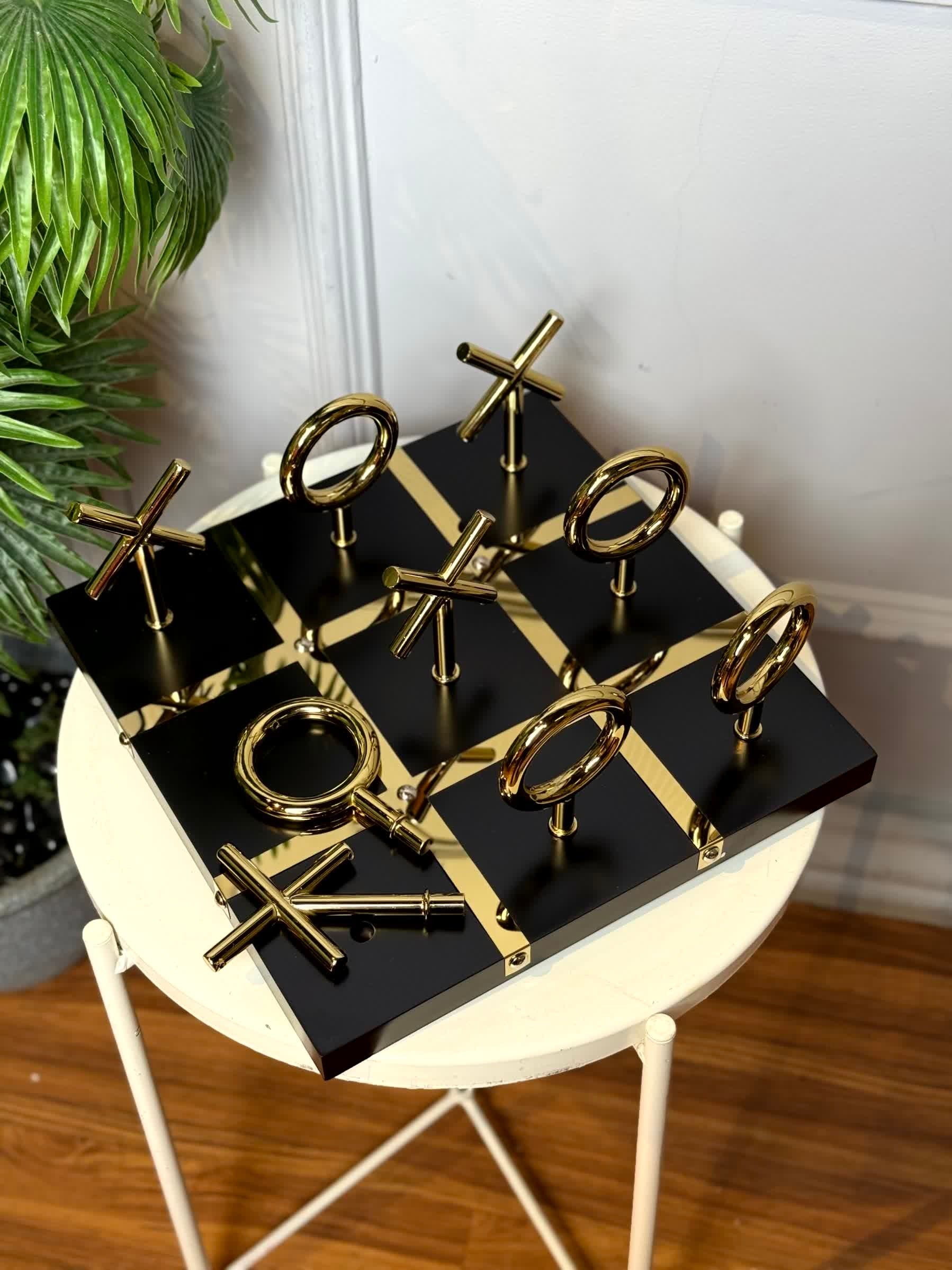 High Objects Sculpted Gold Tic-Tac-Toe Set with black MDF board and gold-finished iron X and O pieces.