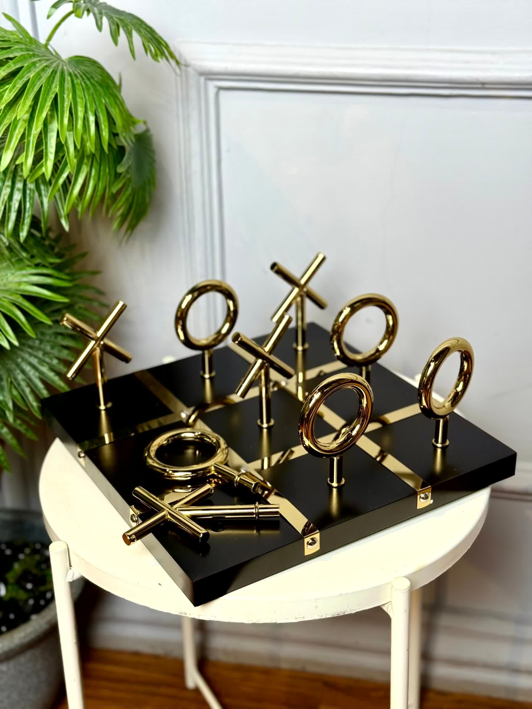 High Objects Sculpted Gold Tic-Tac-Toe Set with black MDF board and gold iron X and O pieces.