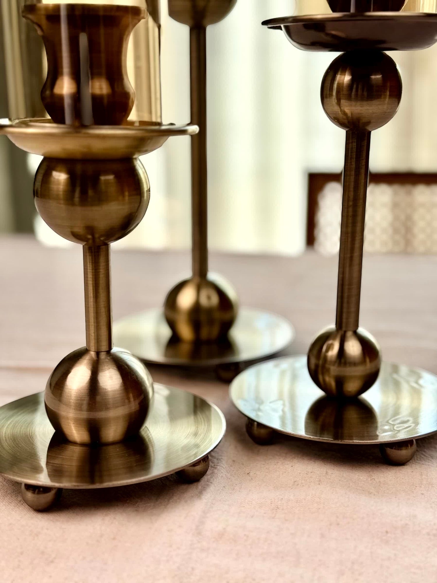 High Objects Seren Column Candle Stand Set in antique brass finish with sphere detail and wide base. Set of 2.