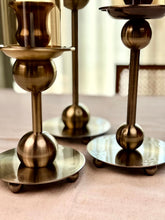 High Objects Seren Column Candle Stand Set in antique brass finish with sphere detail and wide base. Set of 2.