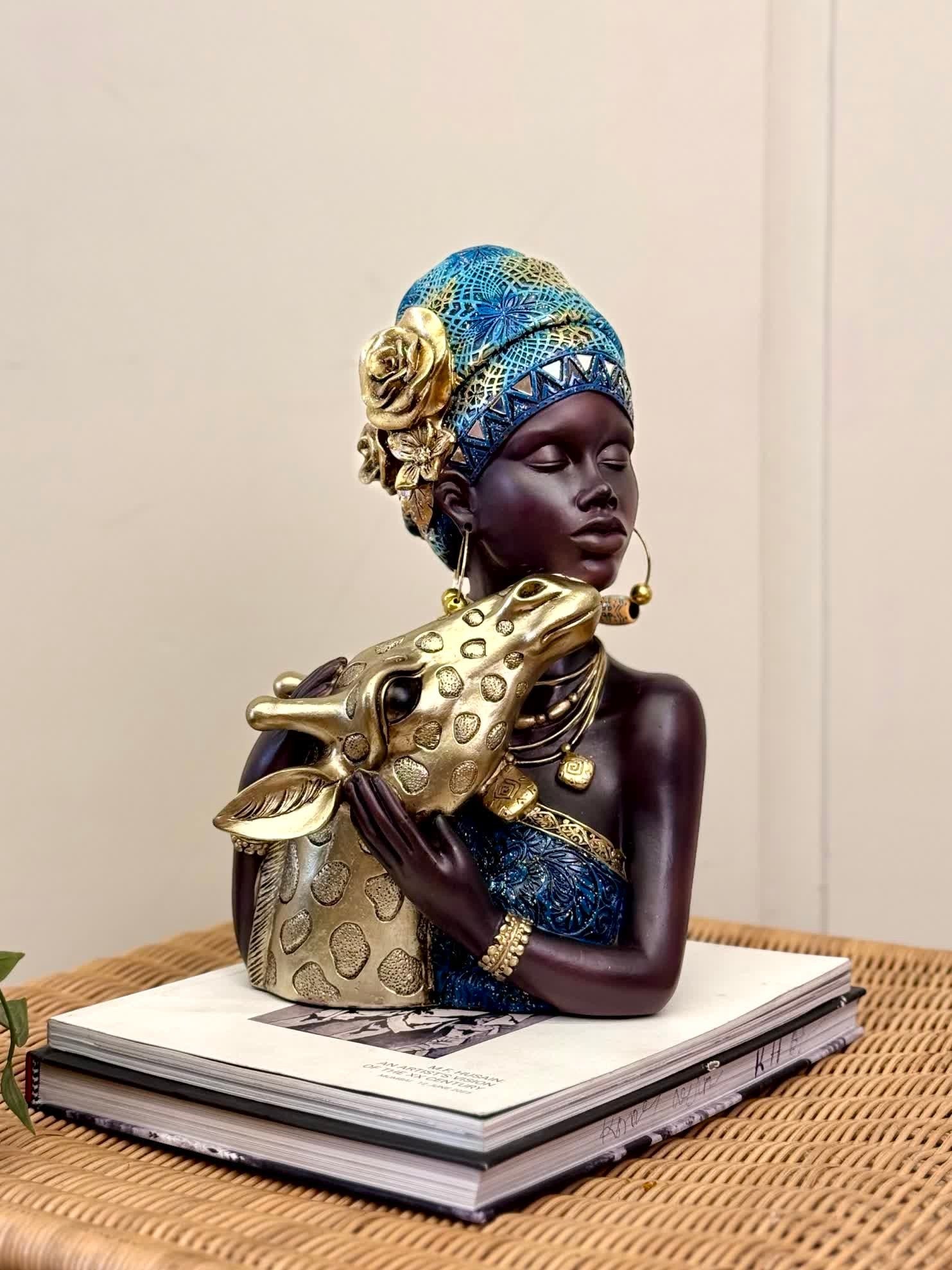 High Objects Serenity Bond Woman &amp; Giraffe Showpiece, a sculpture of a woman in a blue headwrap embracing a giraffe.