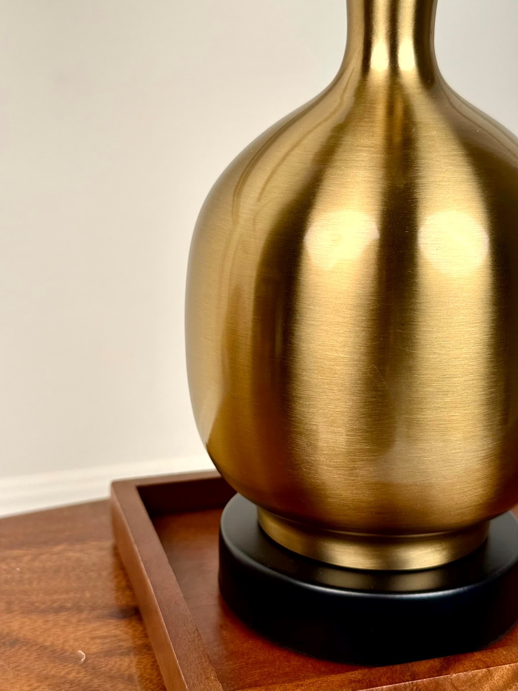 High Objects Solara Sculpted Vase, brushed brass metallic finish, rounded body, slender neck, flared rim, black base.
