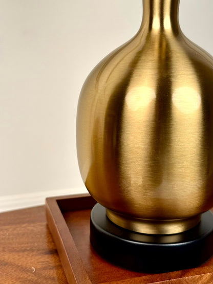 High Objects Solara Sculpted Vase, brushed brass metallic finish, rounded body, slender neck, flared rim, black base.