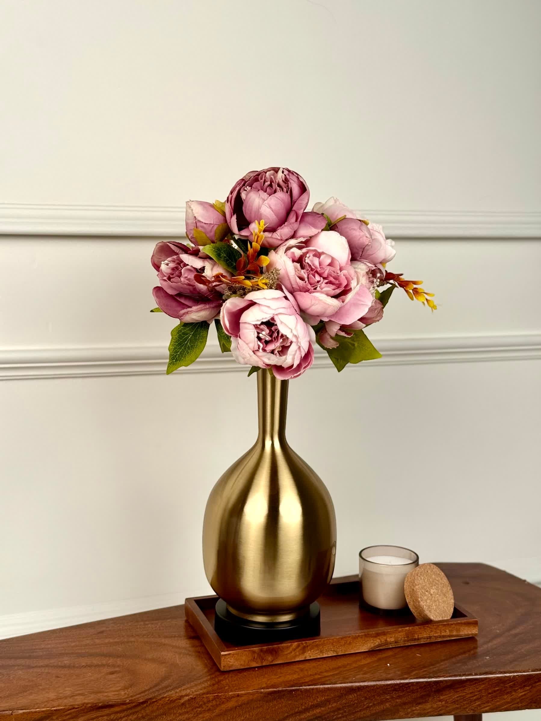 High Objects Solara Sculpted Vase in brushed gold metal with a rounded body and slender neck, holding pink peonies.