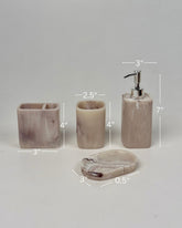 High Objects Stoneaura Bathroom Accessory Set in marbled beige and purple resin. Includes soap dish, toothbrush holder, cup, and lotion dispenser.
