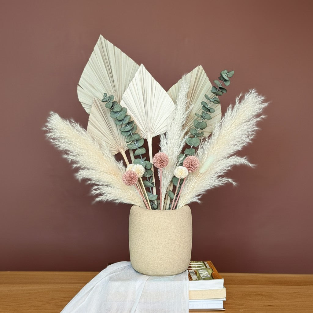 High Objects StoneAura ceramic vase in beige with a textured finish, holding dried bunny tail grass.