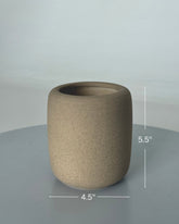 High Objects StoneAura ceramic vase in a natural earthy tone with a matte finish. Cylindrical shape, 5.5" H x 4.5" D.
