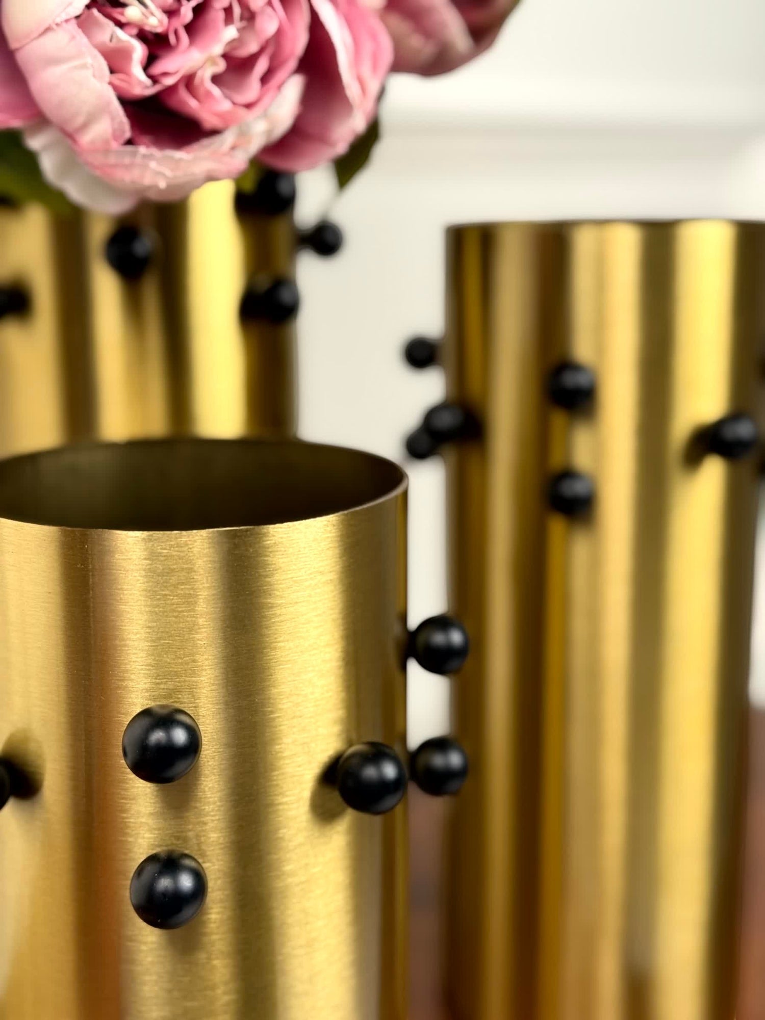 High Objects Studform Metal Vase, gold brushed finish with black studs, cylindrical shape, modern decorative accent.