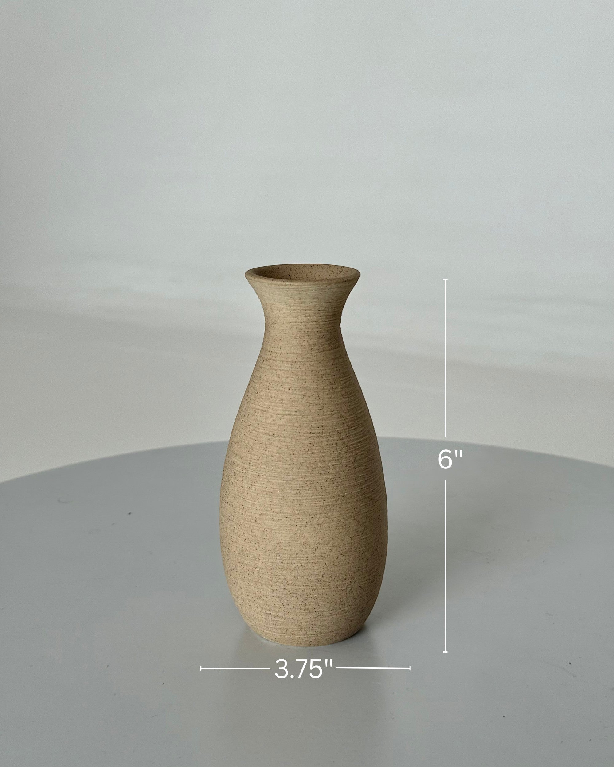 High Objects TerraLume Vase: 6-inch tall, 3.75-inch base, handcrafted ceramic with organic curves and natural clay texture in earthy tones.