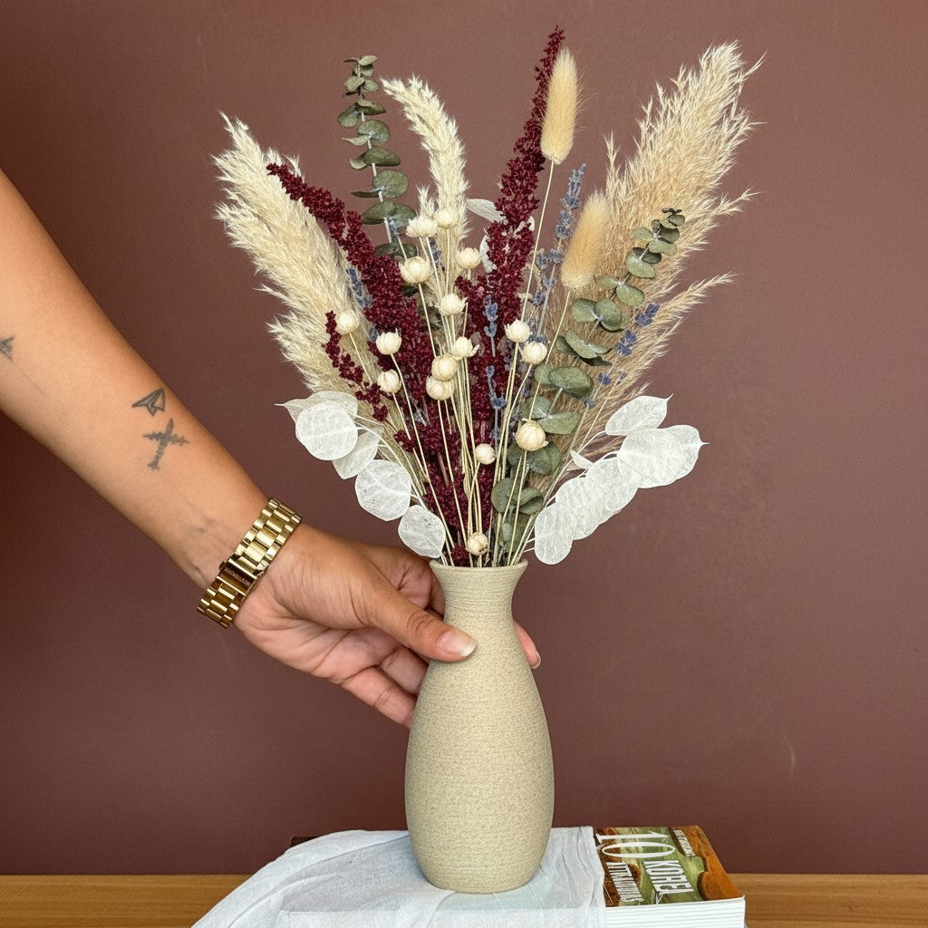 High Objects TerraLume ceramic vase with organic curves and natural texture, holding dried bunny tail grass.