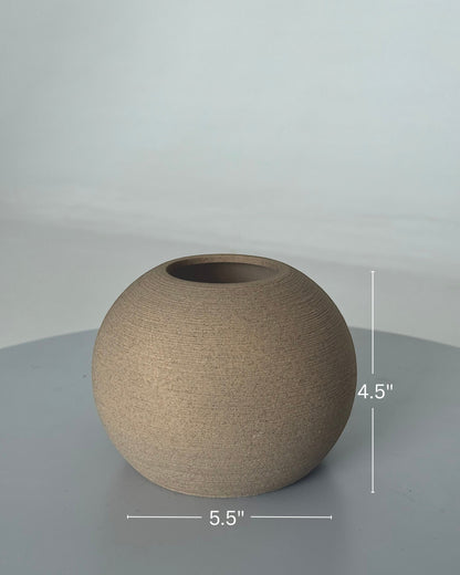 High Objects TerraSphere spherical ceramic vase in a natural earthy tone with a textured finish. Measures 5.5" wide and 4.5" tall.
