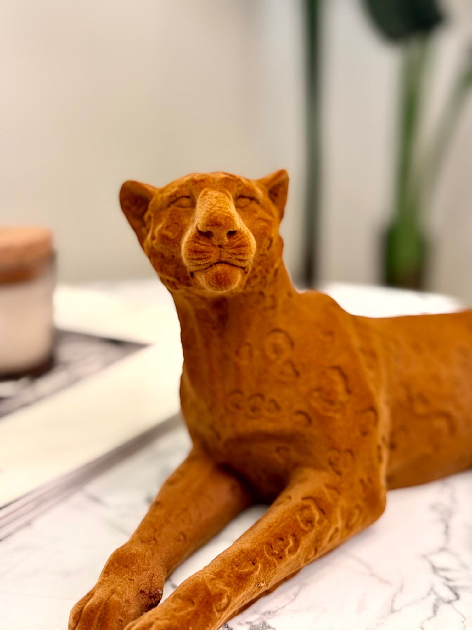High Objects terracotta cheetah showpiece sculpture with carved detailing, lying down in a relaxed pose.