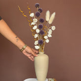 High Objects TerraForm Vase, a handcrafted beige ceramic vase with a natural matte texture, holding dried eucalyptus and pampas grass.