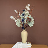 High Objects TerraForm Vase, a handcrafted beige ceramic vase with a matte texture, holding dried floral arrangement.