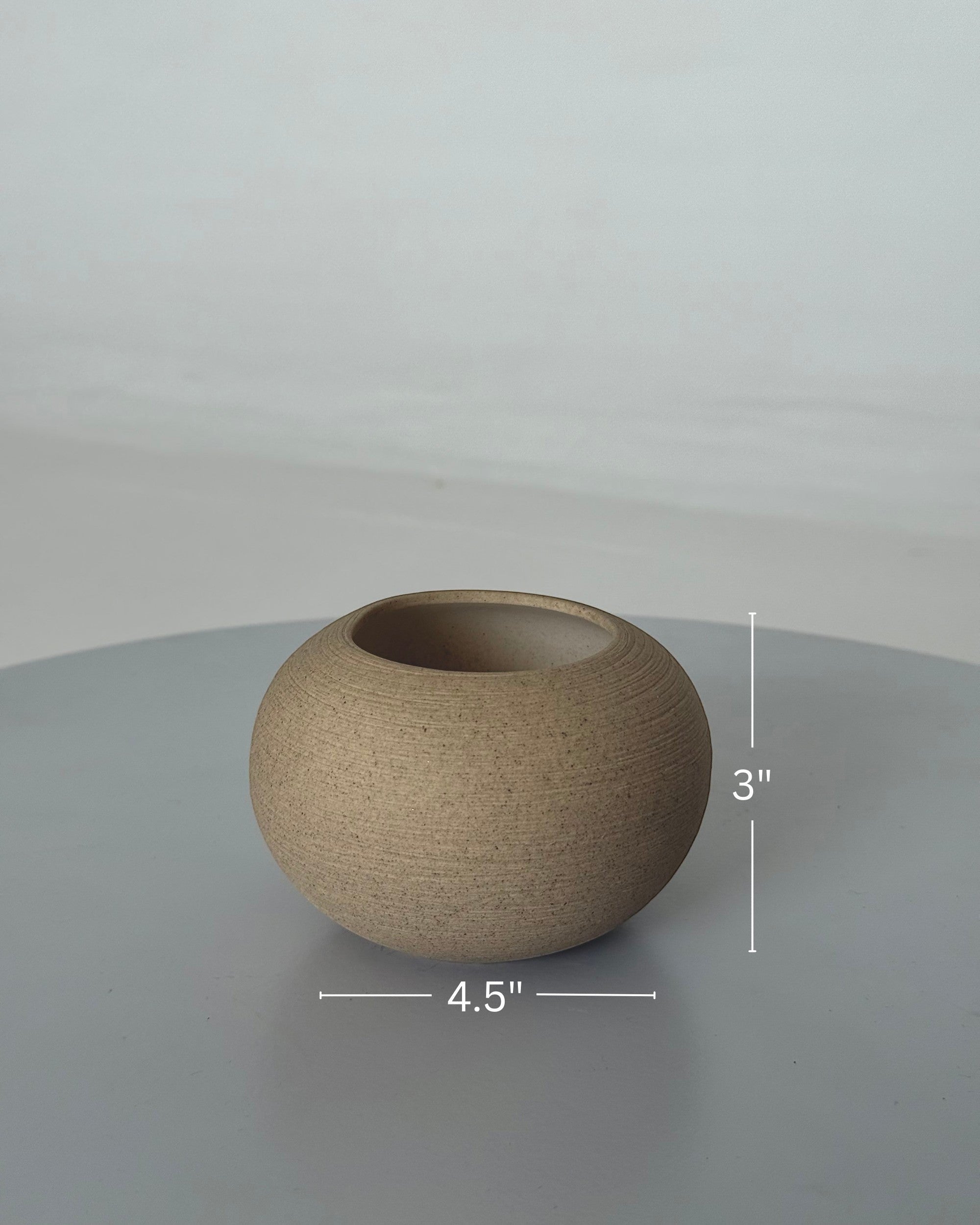 High Objects TerraSphere spherical ceramic vase in natural earthy tone with textured finish. Measures 4.5" W x 3" H.