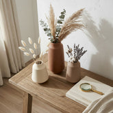 Three High Objects ceramic vases in cream, terracotta, and taupe, featuring textured patterns and dried floral arrangements.